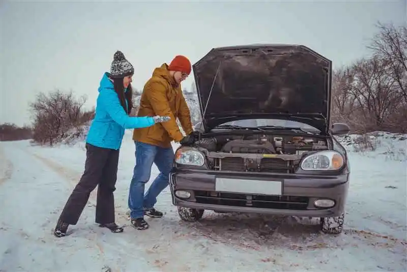 A car with a dead battery, Common signs like dim headlights and a non-starting engine