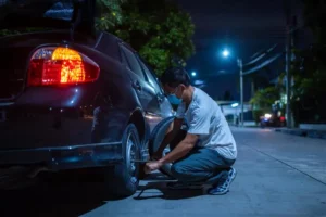 Technician Repairing Tyre Puncture at Night